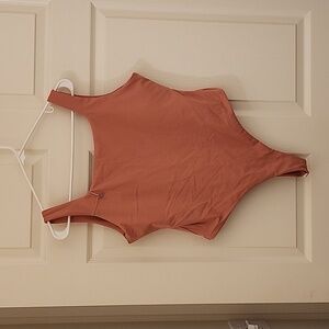 Emerieh Body Suit in a light coral color.
